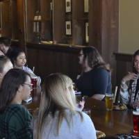 Seidman Alumni sitting around a table at Founders Brewing